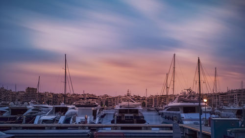 Sailboats in marina at sunset