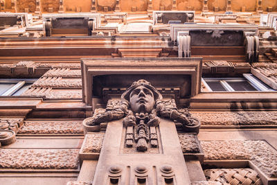 Statue on wall of historic building