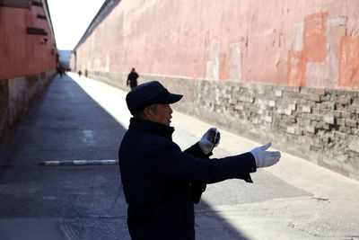 Rear view of man on wall