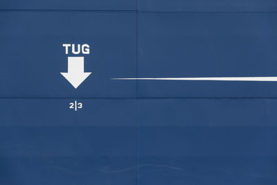 Text and arrow symbol on blue ship