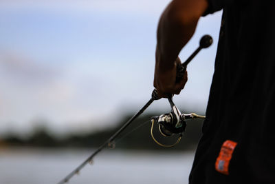 Close-up of a man holding fishing rod