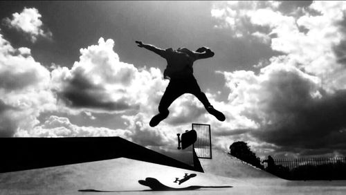 Low angle view of woman jumping in mid-air