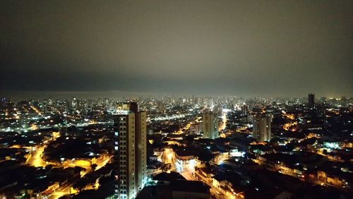 High angle view of illuminated city buildings at night