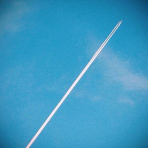 Low angle view of vapor trails in blue sky