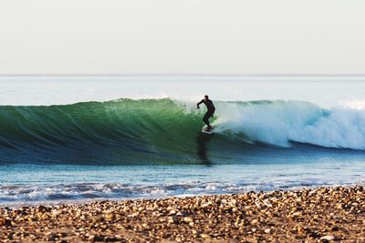 Full length of man on sea shore against sky