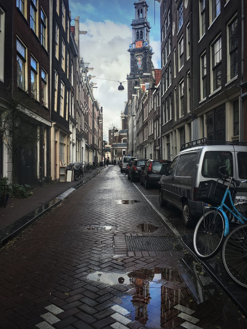 VEHICLES ON ROAD ALONG BUILDINGS