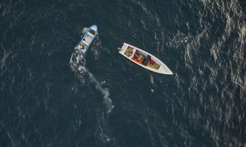 Aerial view of traditional fishing boat in caraballeda with crystal clear turquoise sea, la guaira