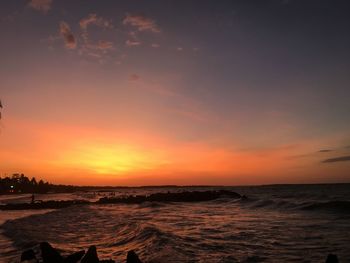 Scenic view of sea against orange sky