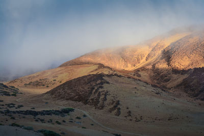 Scenic view of arid landscape against sky