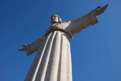 Low angle view of statue against clear blue sky