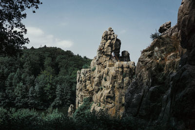 Low angle view of rock formations against sky