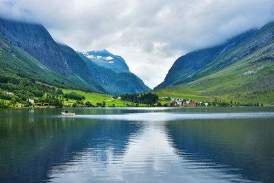 Scenic view of lake and mountains against sky