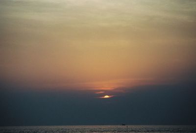 Scenic view of sea against orange sky