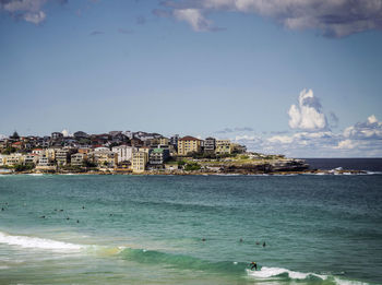 Scenic view of sea and buildings against sky