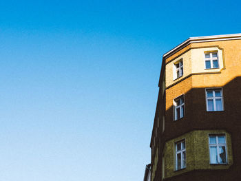 Low angle view of building against clear blue sky