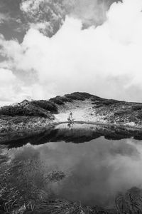 Female tourist on lake bank monochrome landscape photo