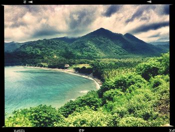 Scenic view of mountains against cloudy sky