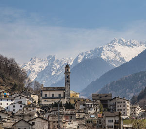 Aerial view of townscape and mountains against sky