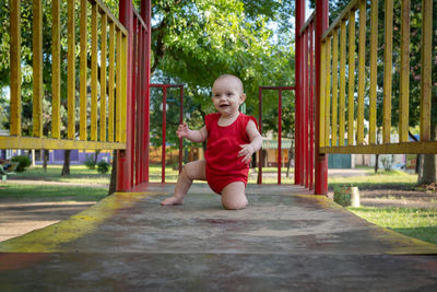 Full length of cute boy playing in playground