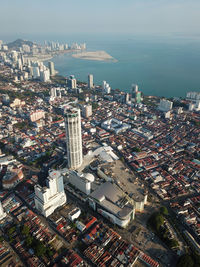 High angle view of buildings by sea against sky