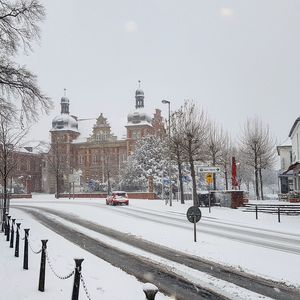 Snow covered city against clear sky