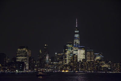 Illuminated buildings against sky at night