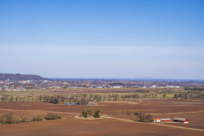 Aerial view of rural landscape in spring with a city in the background