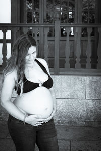 Woman standing against the wall