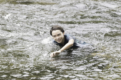 Portrait of smiling young woman in sea