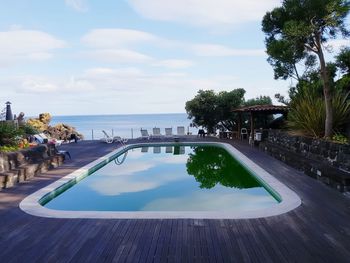 View of swimming pool in sea against sky