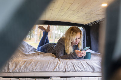 Young woman looking away while sitting in bus