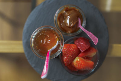 Directly above shot of strawberries and jam on table