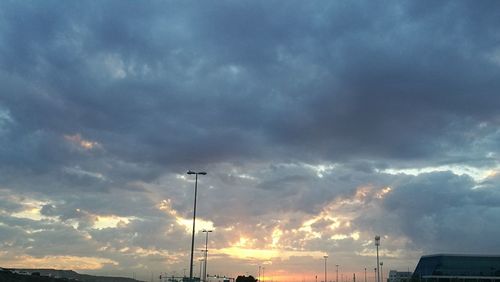 Low angle view of silhouette street light against sky