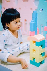 Cute girl playing with plastic toys