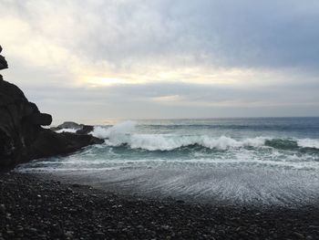 Scenic view of sea against cloudy sky