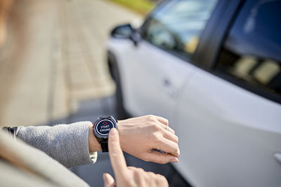 Woman operating car with smart watch