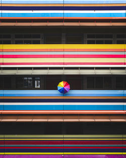 Umbrella at balcony of colorful building