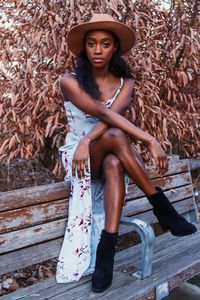 Portrait of young woman sitting outdoors
