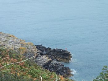 High angle view of rocks in sea against sky