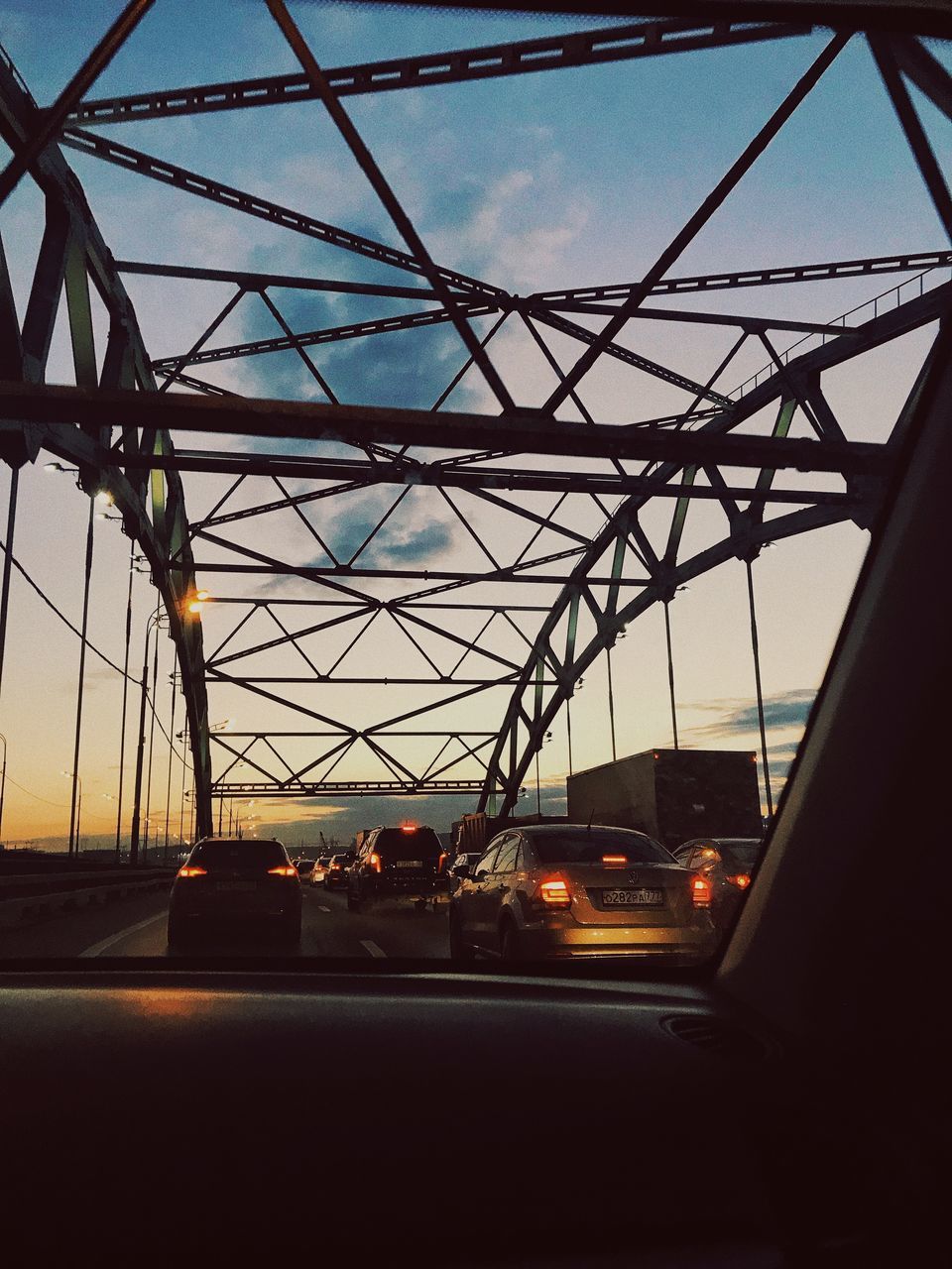 LOW ANGLE VIEW OF BRIDGE IN CITY AGAINST SKY