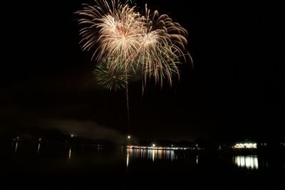 Low angle view of firework display at night