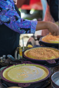 Midsection of man preparing food at market