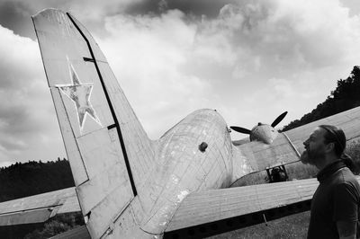 Side view of man and woman standing against sky