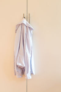 Clothes drying on white wall at home