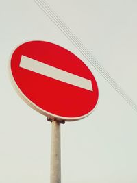 Low angle view of road sign against clear sky