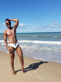 Portrait of shirtless man standing at beach