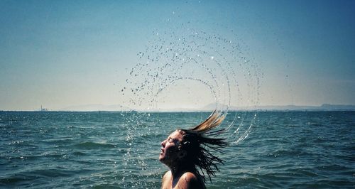 Woman jumping in water