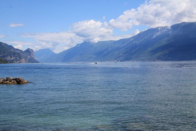 Scenic view of sea and mountains against sky