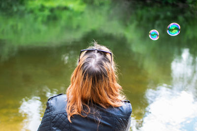 Portrait of woman with bubbles in lake