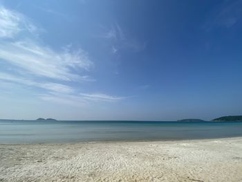 Scenic view of beach against blue sky